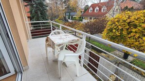 A balcony with a table and chairs, a view of the neighborhood, and a railing. - Holiday apartment near the beach with internet (Siófok)
