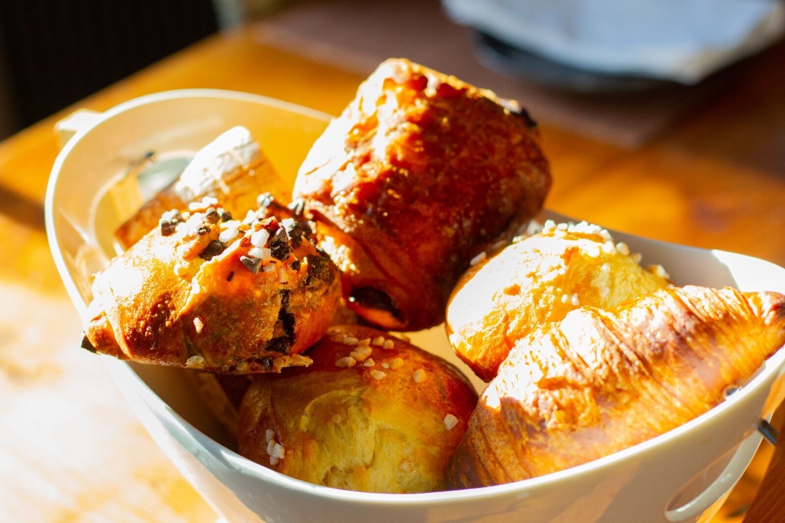 A bowl of pastries with sesame seeds and a sprinkle of salt.