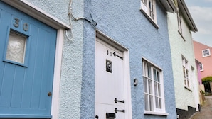 A row of blue houses with white doors and windows, numbered 30 and 31. - 30 Sherborne Lane (Lyme Regis)