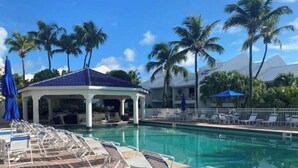 A pool area with lounge chairs and a gazebo. - Oceanfront, 4 balcony condo: Stunning Sunsets (Sint Maarten)