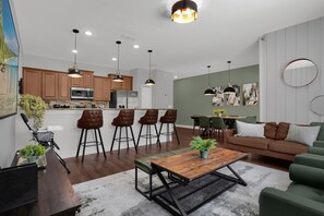 A modern living space with a kitchen, dining area, and seating area. - 4 BD/ 3 BA/ Paradise Palms (2939 BP) (Kissimmee)