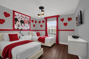A bedroom with two beds, a TV, and heart-themed decorations. - 4 BD/ 3 BA/ Paradise Palms (2939 BP) (Kissimmee)