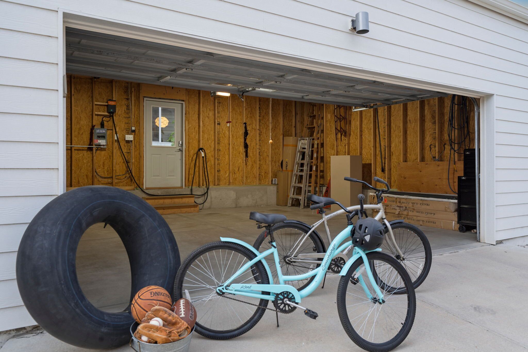 A garage with a bicycle and sports equipment.