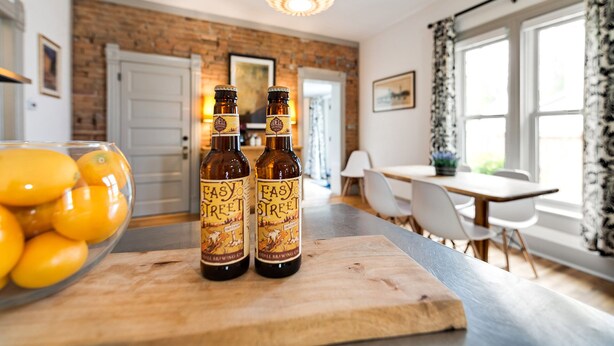 A modern kitchen with a wooden countertop, two bottles of Easy Street beer, and a bowl of lemons. - Lola House! Cozy Comfort, Prime Old Town Location (Fort Collins)