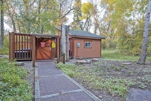 Escape to a secluded cabin nestled among the trees, surrounded by natural vegetation and a tranquil atmosphere.