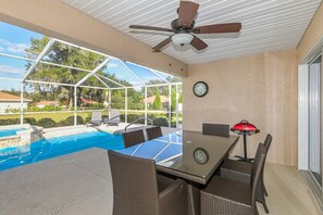 A covered outdoor area with a pool, seating, and a table with chairs. - Trailside Oasis: 3BR Pool & Spa – Minutes from Trail, Ocala & Crystal River (Inverness)