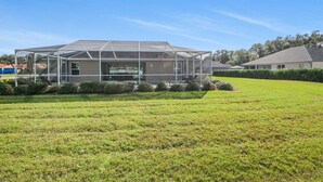 A house with a large covered patio area. - Trailside Oasis: 3BR Pool & Spa – Minutes from Trail, Ocala & Crystal River (Inverness)