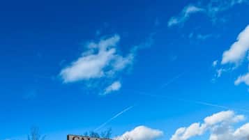 A motel sign with the name "Calabogie Motor Inn" against a clear blue sky with some clouds.