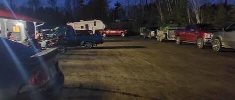 A campground with RVs and trailers parked on a dirt ground.
