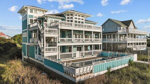 A multi-story building with balconies and a swimming pool. - Soundfront, Pool, Hot Tub, Elevator, Private Dock, Boat Ramp, & Game Room (Salvo)