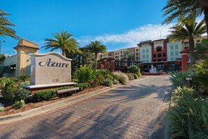 A hotel entrance with a sign reading "Azure 1150," paved pathway, and surrounding greenery.