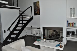Comfort Apartment | Living area | 55-inch Smart TV with cable channels, TV, fireplace