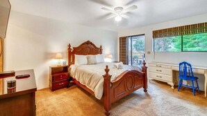 A bedroom with a wooden bed, bedside tables, a desk, and a chair. - D & D Retreat - Quiet Neighborhood! (Cannon Beach)