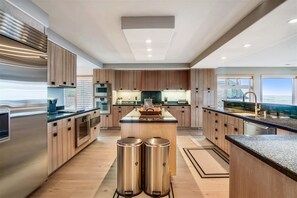 Enjoy cooking in this well-equipped kitchen with a central island, sink, and ample counter space.