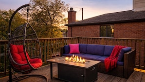 A deck with a fire pit, a swing chair, and a sofa. - Luxe Duplex - Private Gym -Huge Backyard -Arcade- King Beds - Garage-EV Charger (Chicago)