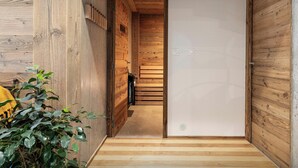 A wooden interior with a staircase leading to a room.