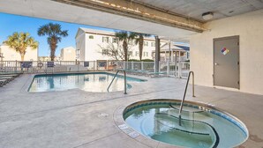 An outdoor swimming pool area with multiple pools and lounge chairs. - Spacious 5 bedroom oceanview condo - Cherry Grove Beach (North Myrtle Beach)