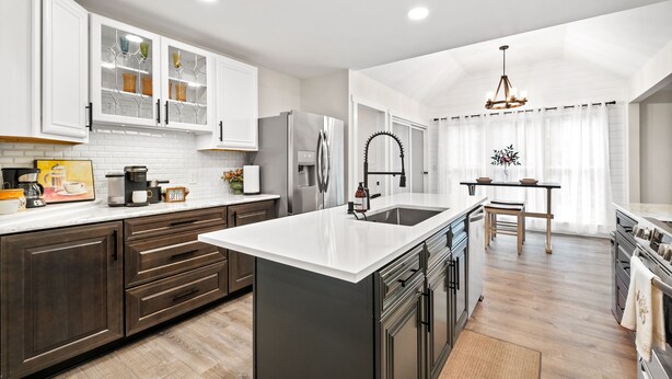 A modern kitchen with white cabinetry, a central island, and a dining area with a chandelier. - Renovated Ranch Home. Pet Friendly, Game Room, Fire Pit, Grill, Covered Porch (Woodstock)