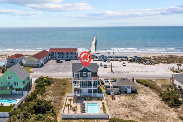 A coastal hotel with a swimming pool, beach access, and ocean views.