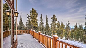 A wooden deck with a snow-covered railing, leading to a forested area. - 22STR-00367 Fairplay Cabin ~ 6 Mi to Downtown! (Fairplay)