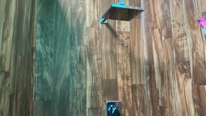 A shower area with a wooden floor and a metal showerhead. - Simple convenience studio in tropical forestG4 (Mountain View)