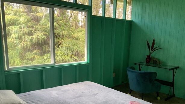 A room with a bed, a chair, a small table, and a window with a view of greenery. - Simple convenience studio in tropical forestG4 (Mountain View)