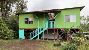 A two-story house with a staircase leading to a porch. - Simple convenience studio in tropical forestG4 (Mountain View)