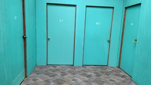 A hallway with three teal-colored doors labeled G5, G7, and G8. - Simple convenience studio in tropical forestG4 (Mountain View)