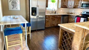 A compact kitchen with a refrigerator, sink, and microwave. - Best of Tides - Make family memories! (Galveston)