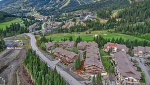 A residential area with houses, a road, and a ski resort in the background. - Outdoor Adventure at Sun Peaks 33 (Sun Peaks)