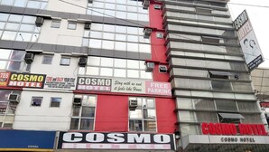 A hotel with multiple signs advertising amenities like air-conditioned rooms, in-house movies, and food and beverage services. - Cosmo Hotel Espana Near Ust (Manila)