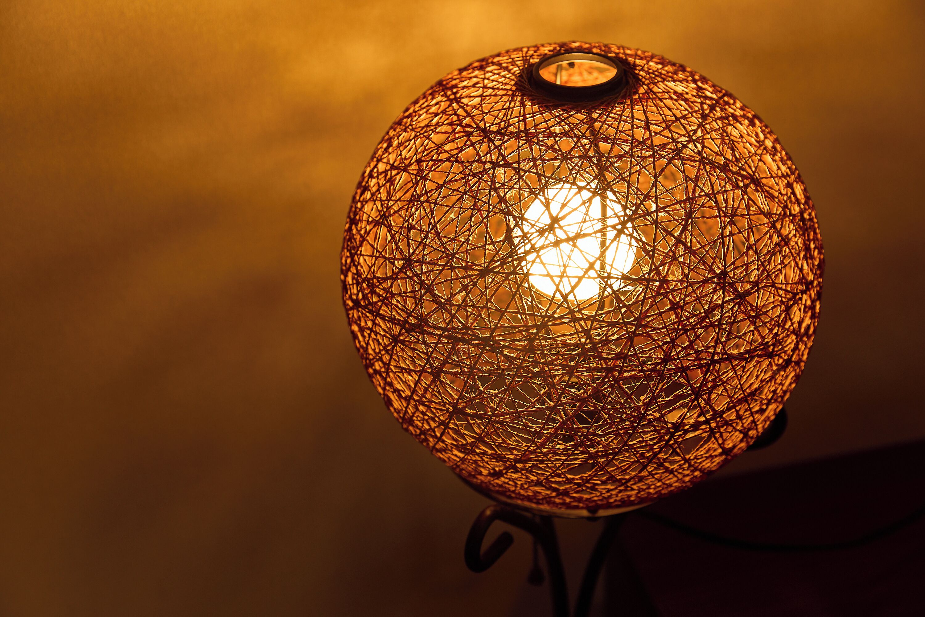 A spherical lamp with a complex wireframe design.