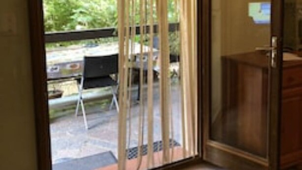 A room with a sliding glass door leading to a patio area. - Ground floor in villa (L'Île-Rousse)