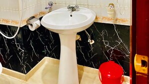 A bathroom with a white sink, a mirror, and a shower enclosure. - Royal Village Hotel Dar Es Salaam (Dar es Salaam)
