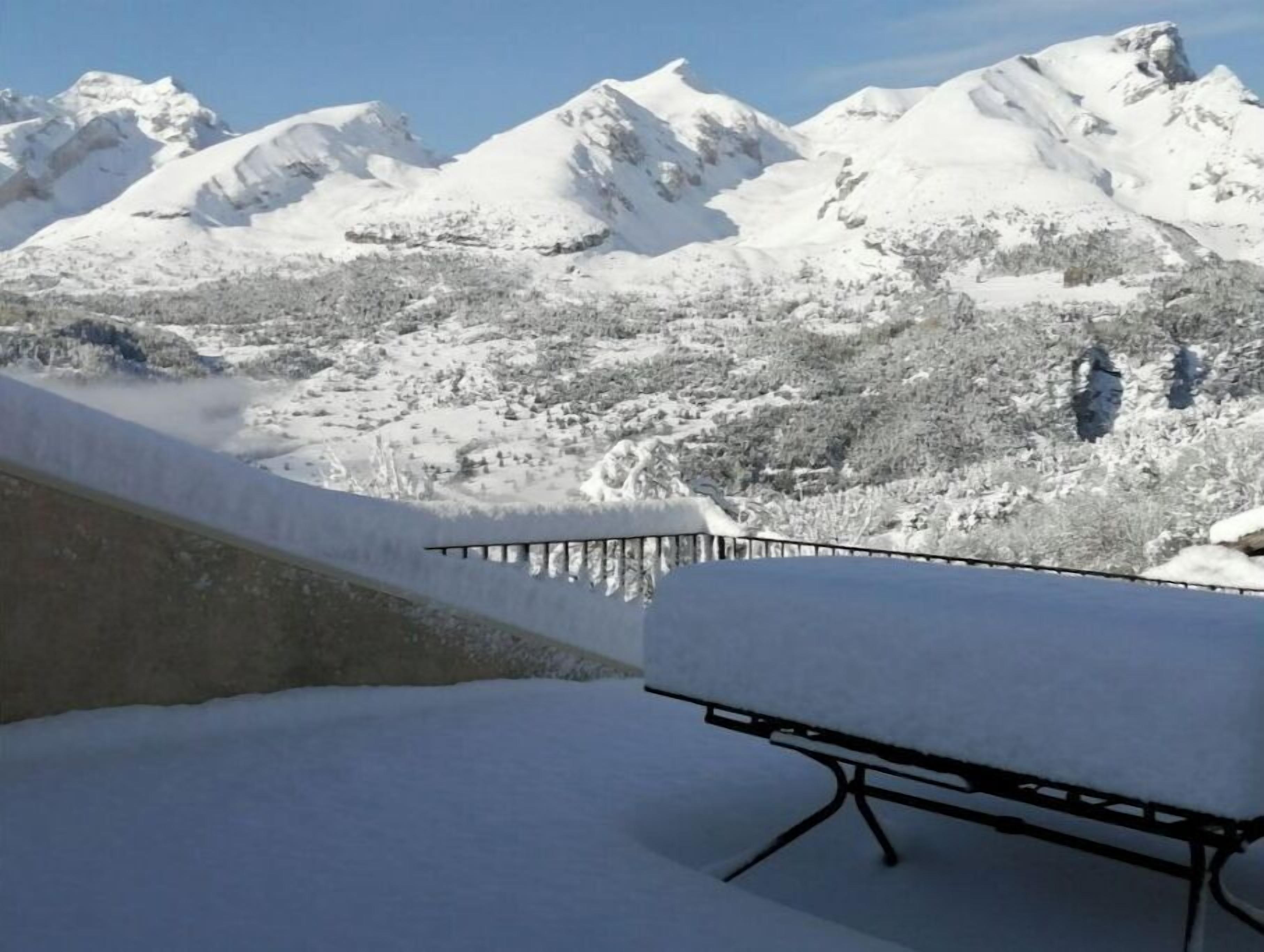 A snow-covered mountain landscape with a clear sky.