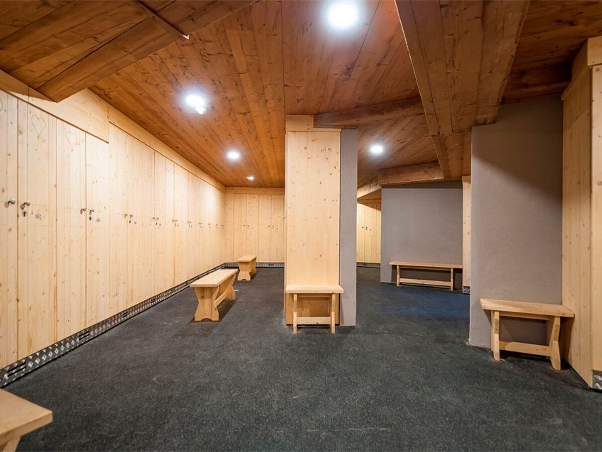 Un interno in legno con panche e un pavimento rivestito di moquette.
