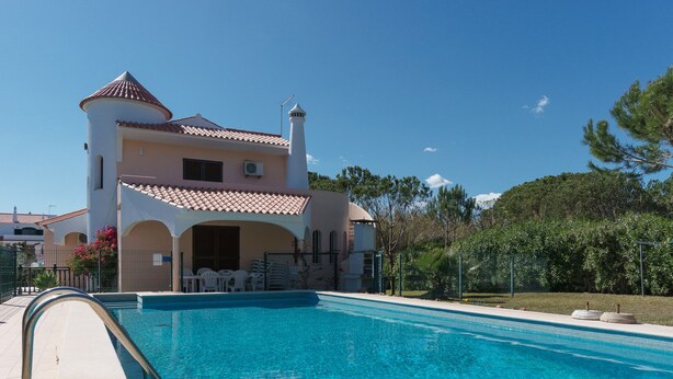A two-story building with a swimming pool in front. - Costa Red Villa, Quarteira, Algarve (Semino)