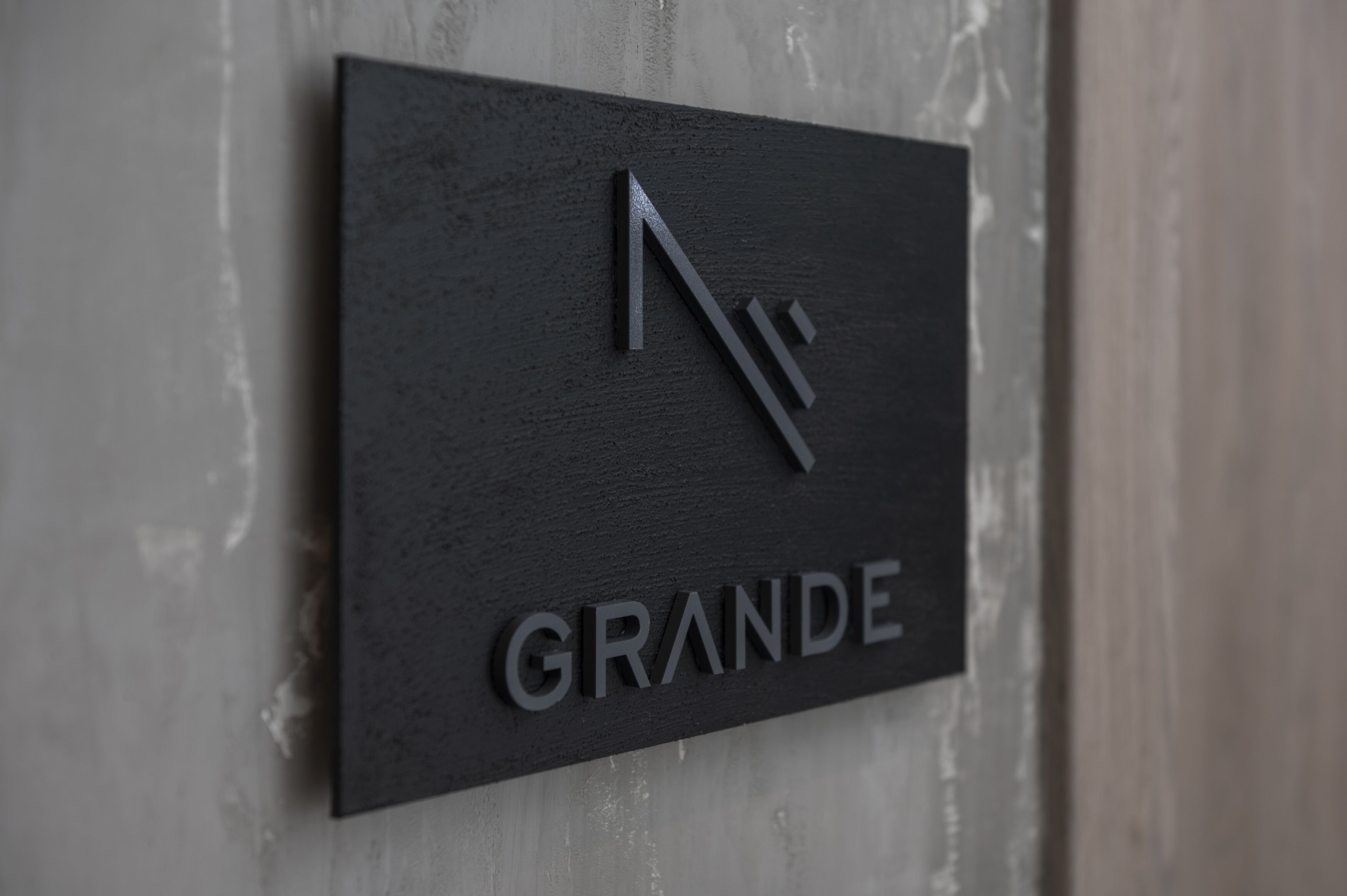 A black sign with the word "GRANDE" and a stylized 'N' logo.