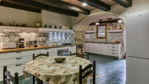 Una cocina con una mesa de comedor, sillas y un refrigerador.