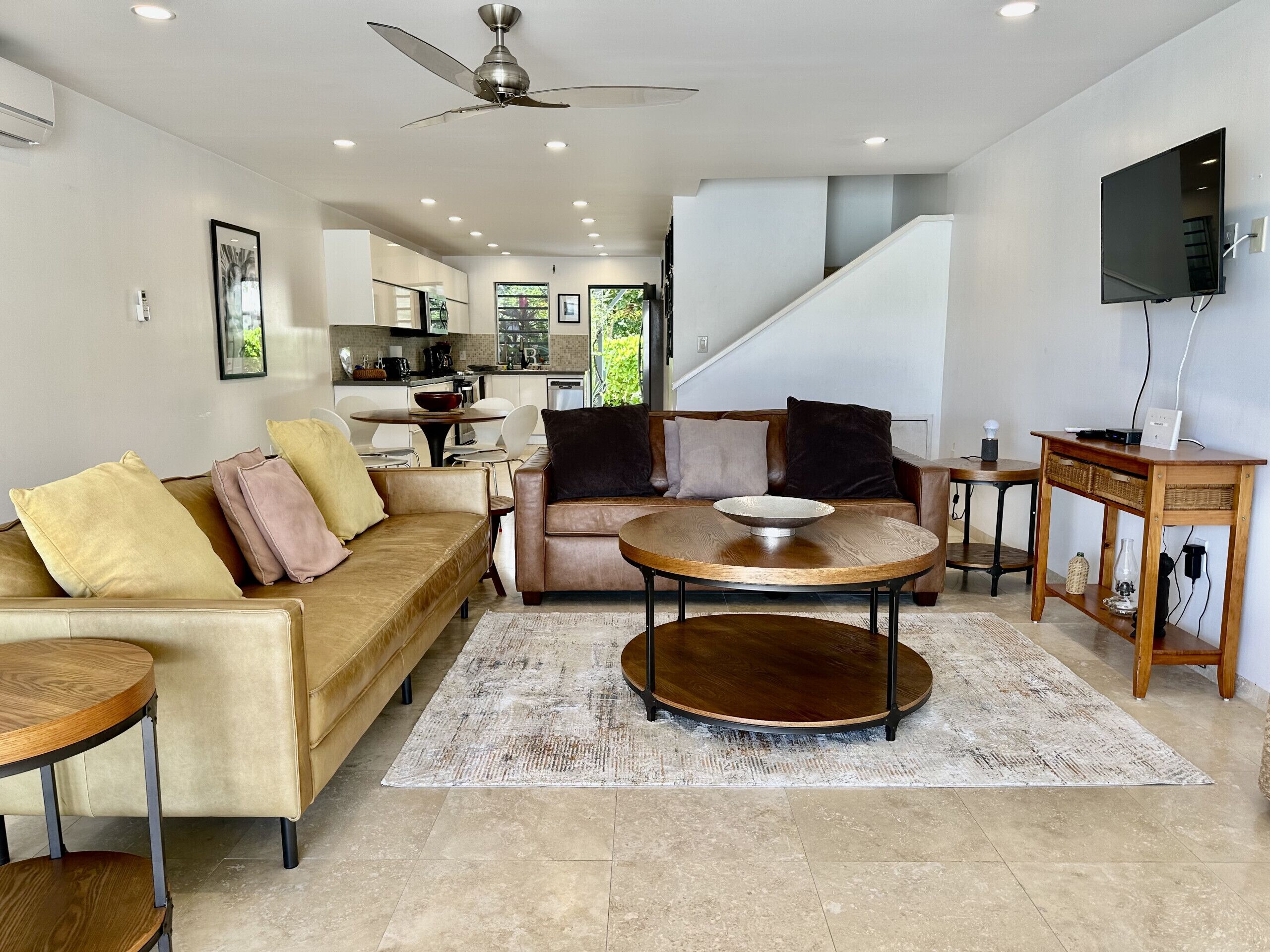 A modern living room with a sofa, coffee table, and TV stand.