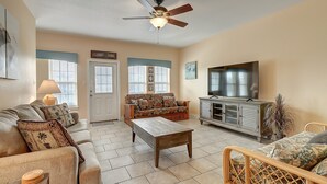A living room with a sofa, coffee table, and TV stand.