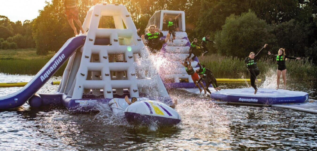 An inflatable water park structure with slides and a platform.