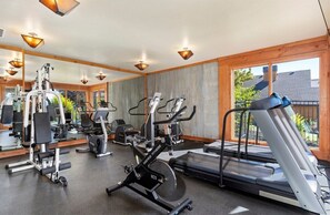 A gym with exercise equipment, a treadmill, and large windows. - Luxurious Mountain Home with 7 BRs private hot tub (Eden)
