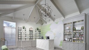 A spacious room with a high ceiling, a central island with shelves, and a large floral mural on the wall. - Ocean Views in Spacious Unit at Kingston Plantation, come Relax on the Beach (Myrtle Beach)