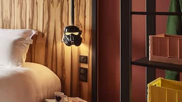 A bedroom with a bed, bedside table, and a shelf unit.