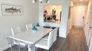 A modern kitchen with white cabinetry, a stainless steel refrigerator, and a microwave. - Beautiful Oceanview Townhouse 2 Bed 2.5 Bath SH 430 (St. Augustine)