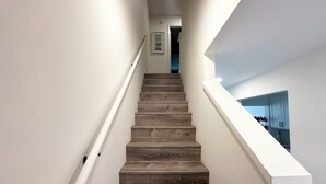 A wooden staircase with white walls and a white handrail. - Beautiful Oceanview Townhouse 2 Bed 2.5 Bath SH 430 (St. Augustine)