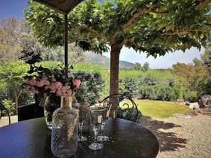 A table set outdoors with a view of a garden and hills. - 2 3* POOL VILLAS WITH PANORAMIC VIEWS BETWEEN THE SEA AND THE MOUNTAINS (Porto-Vecchio)