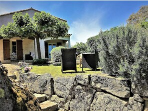 A rustic stone wall, a house with a tiled roof, and a tree in the foreground. - 2 3* POOL VILLAS WITH PANORAMIC VIEWS BETWEEN THE SEA AND THE MOUNTAINS (Porto-Vecchio)