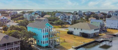 A coastal residential area with houses, a dock, and a water body.
